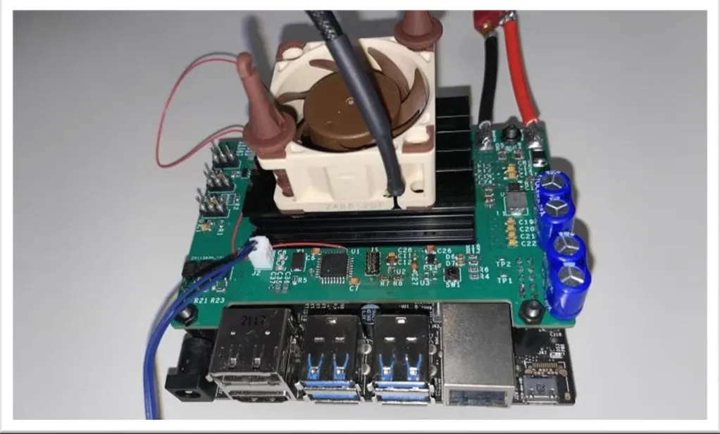 Figure 5: the first prototype board mounted on the Jetson with its cooling fan, battery leads and blue capacitors attached.